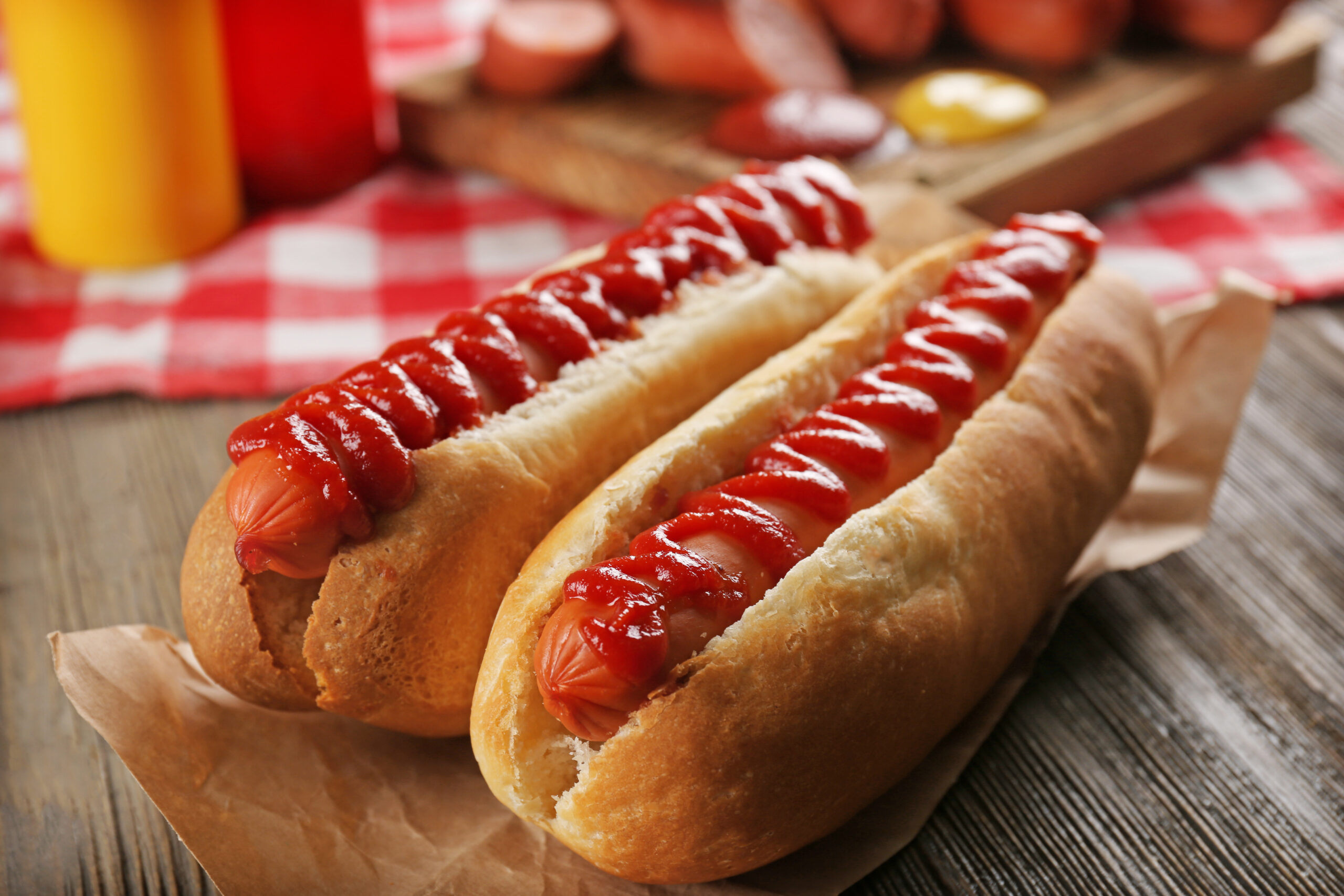 Hot dogs with ketchup on a plate.