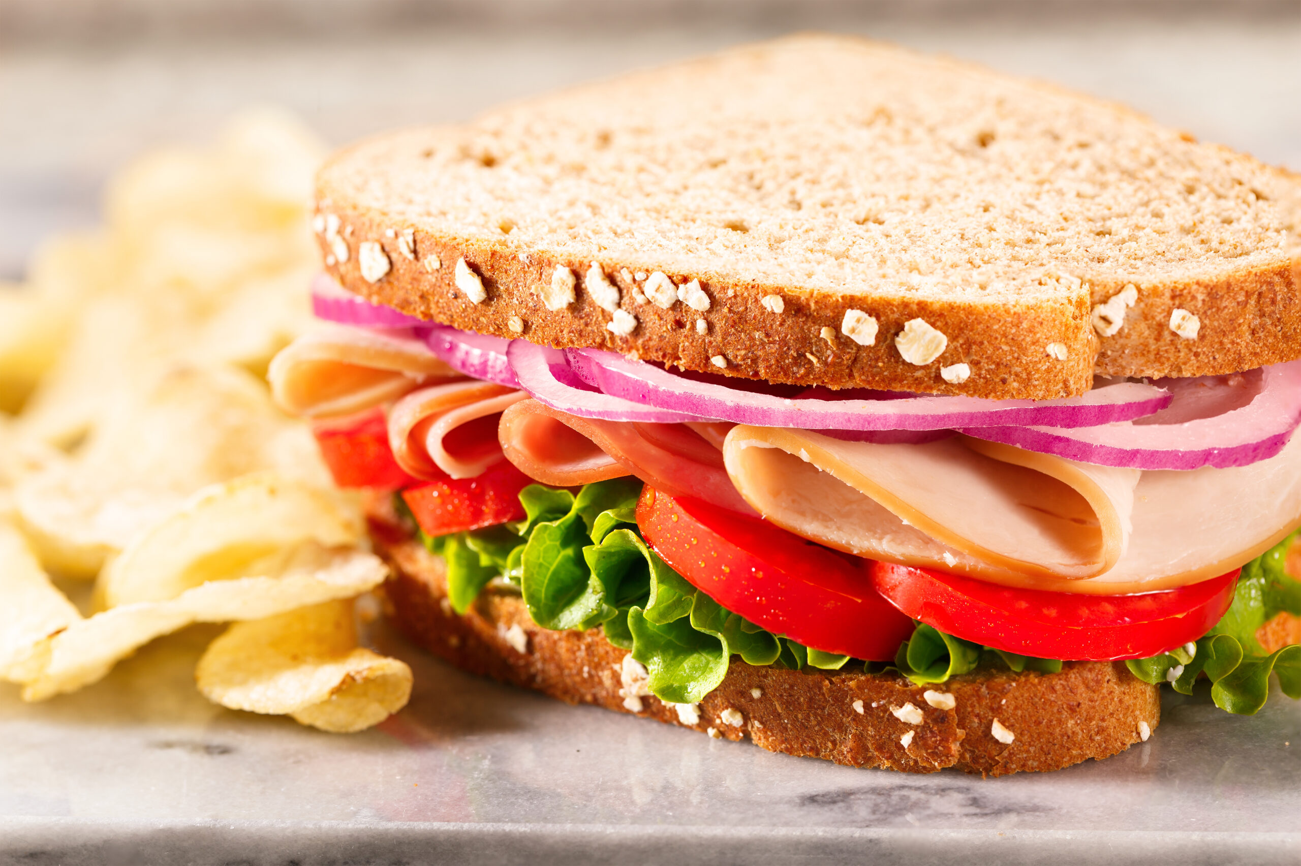 Turkey sandwich with lettuce and tomatoes.