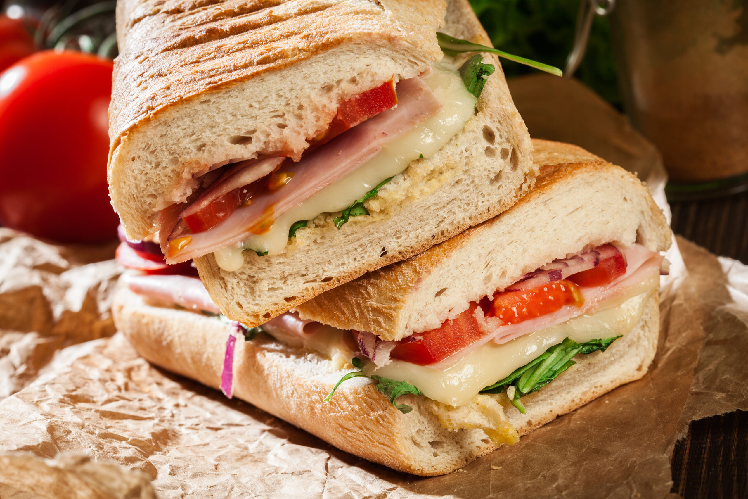 Ham and cheese sub with lettuce and tomatoes.