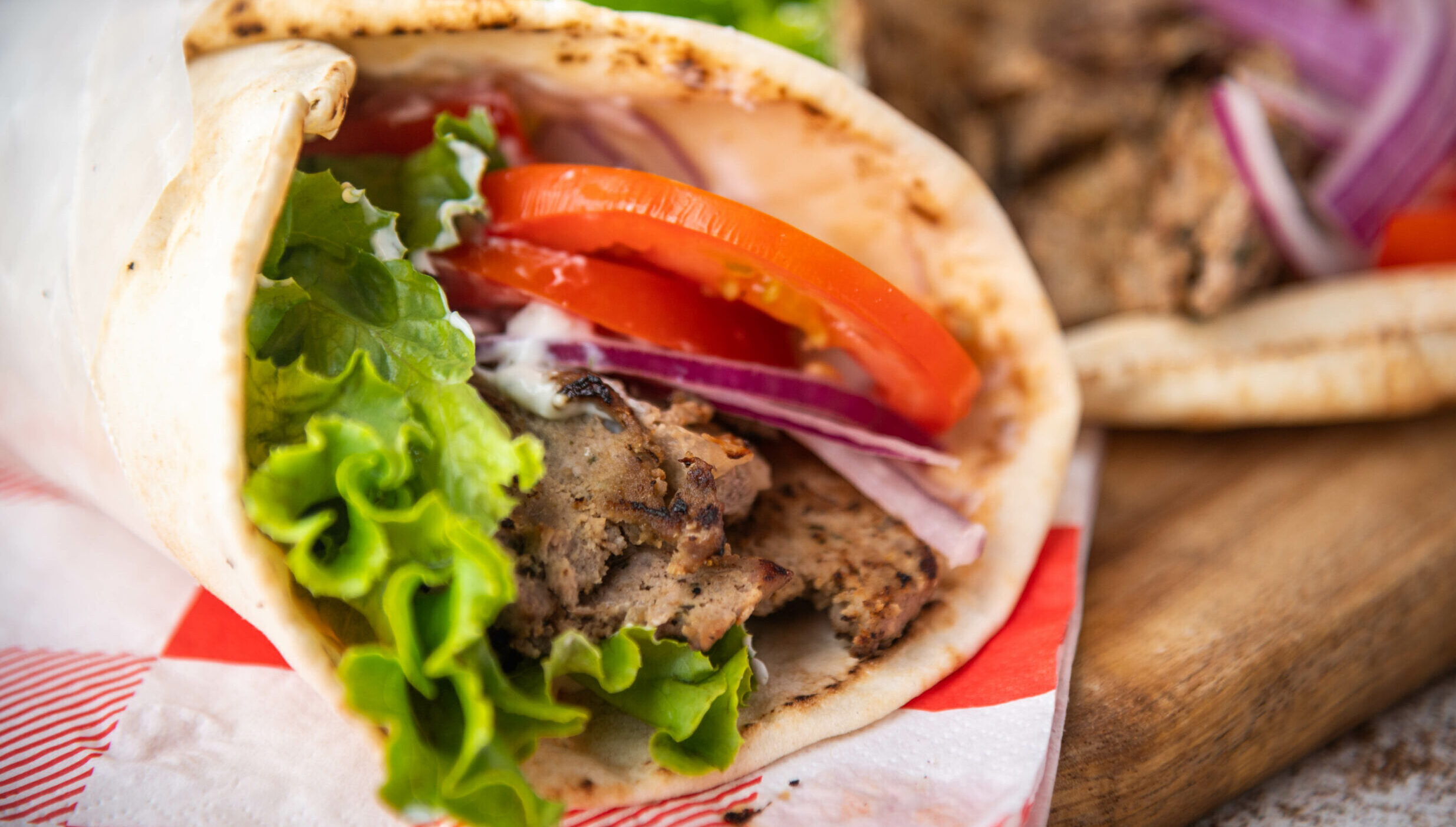 Steak/lamb gyro with lettuce and tomatoes.