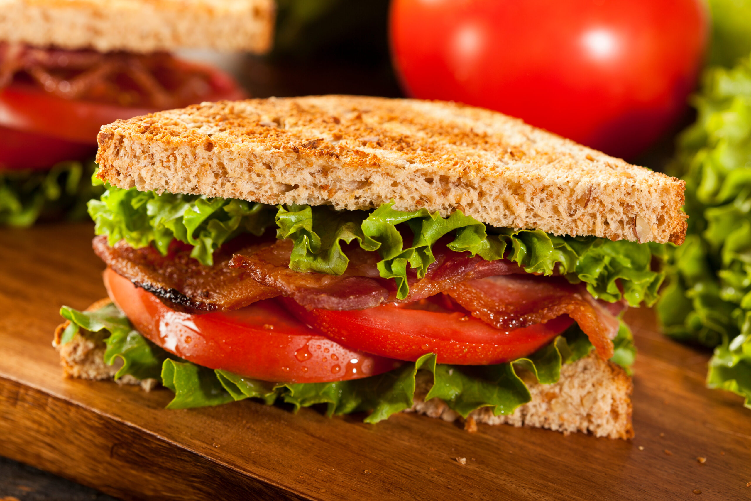 Bacon, Lettuce, Tomato sandwich sliced in a triangle.