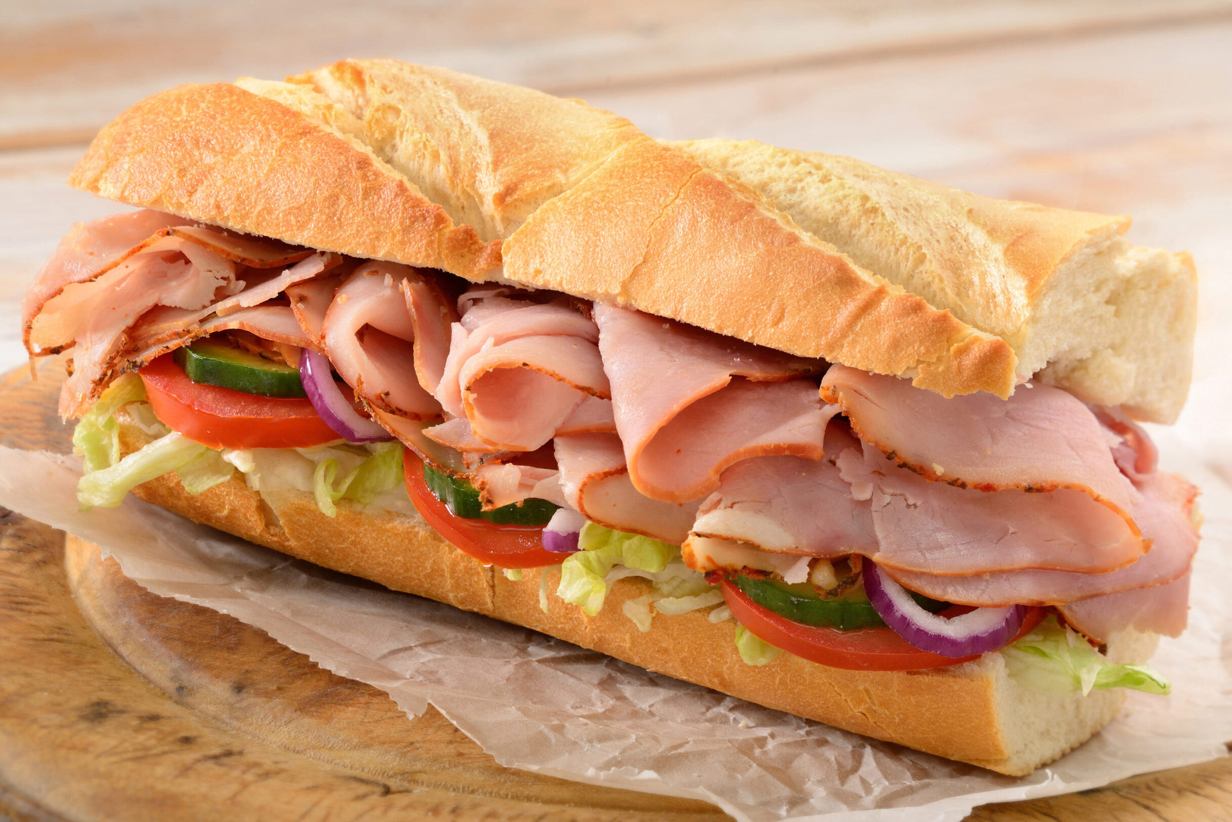 Ham sub with lettuce and tomatoes.