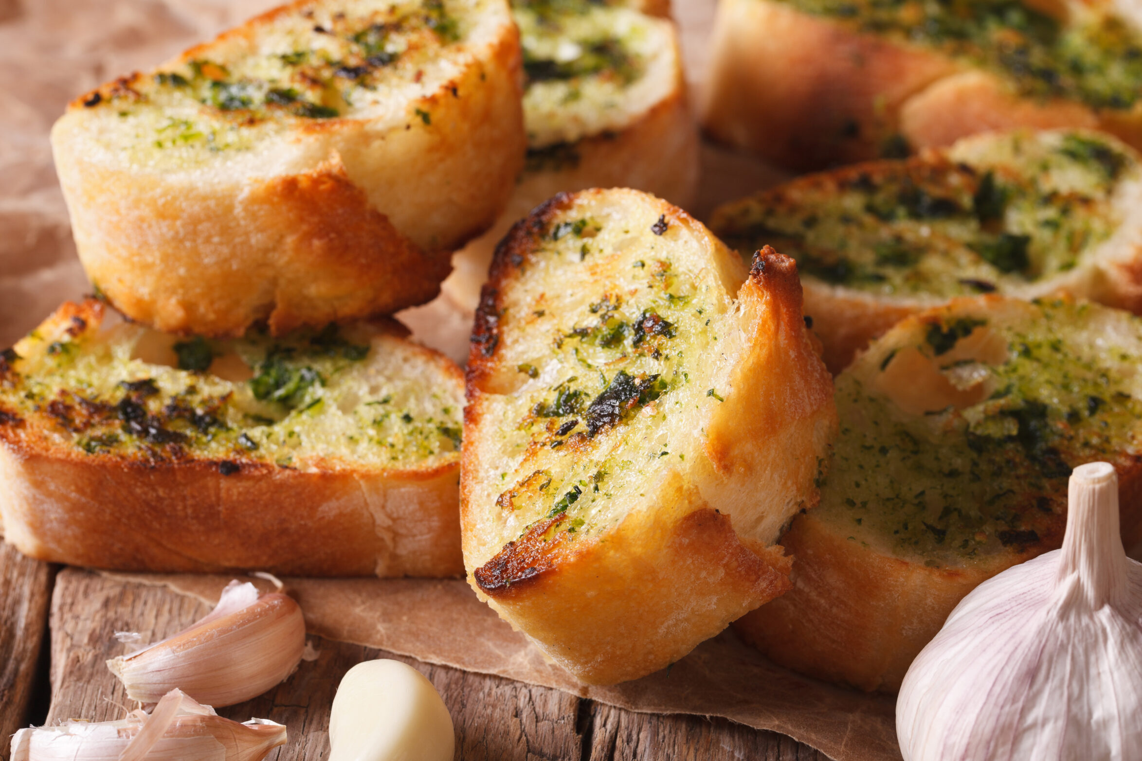 Garlic bread on a chopping board.